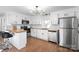 Modern kitchen featuring white cabinets, butcher block countertops, and stainless steel appliances at 717 Perth Rd, Troutman, NC 28166
