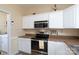 Kitchen featuring stainless steel appliances, neutral countertops, and white cabinets at 7500 Grabill Dr, Charlotte, NC 28269