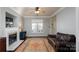 Cozy living room featuring a fireplace, a comfortable couch, dark wood floors, and lots of natural light at 7500 Grabill Dr, Charlotte, NC 28269