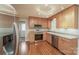 Well-lit kitchen featuring wood cabinets, stainless steel appliances, and hardwood floors at 775 Summerwood Dr, Rock Hill, SC 29732