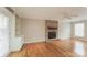 Bright living room with hardwood floors, brick fireplace, built-in shelving and a ceiling fan at 775 Summerwood Dr, Rock Hill, SC 29732