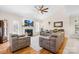 Cozy living room with comfortable seating, fireplace with tv above, and ceiling fan at 8020 Harrington Woods Rd, Charlotte, NC 28269