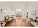 Bright and airy living room with hardwood floors and a view into the formal dining room at 8020 Harrington Woods Rd, Charlotte, NC 28269