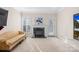 A bright sitting room features a green marble fireplace, lots of light from windows and an exterior door at 8020 Harrington Woods Rd, Charlotte, NC 28269