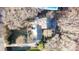 Aerial view of a property with mature trees and a swimming pool, offering privacy and outdoor enjoyment at 8133 Strawberry Ln, Charlotte, NC 28277