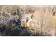 Aerial view showcases the home's setting amidst mature trees and landscaped grounds for privacy at 8133 Strawberry Ln, Charlotte, NC 28277