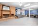 Spacious basement featuring a brick fireplace, comfortable seating, and a classic pool table for entertainment at 8133 Strawberry Ln, Charlotte, NC 28277