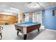 Basement game room with a pool table, fireplace, and ample space for recreation and relaxation at 8133 Strawberry Ln, Charlotte, NC 28277