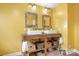 Bathroom with a double sink vanity, tiled backsplash and decorative mirrors at 8133 Strawberry Ln, Charlotte, NC 28277
