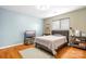 Cozy bedroom with hardwood floors, neutral walls, and comfortable furnishings at 8133 Strawberry Ln, Charlotte, NC 28277
