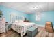 Cozy bedroom with a decorative headboard, light blue walls, and bright natural light from the window at 8133 Strawberry Ln, Charlotte, NC 28277