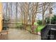 Wooden deck with outdoor seating and a grill, ideal for enjoying views of the landscaped backyard at 8133 Strawberry Ln, Charlotte, NC 28277