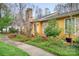 Well-maintained home with stone accents, mature landscaping, and a welcoming walkway at 8133 Strawberry Ln, Charlotte, NC 28277