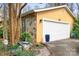 Attached two-car garage with stone accents and well-maintained landscaping, adding curb appeal at 8133 Strawberry Ln, Charlotte, NC 28277