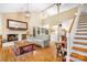 Inviting living room features a brick fireplace, wood floors, and an open layout with bright, natural light at 8133 Strawberry Ln, Charlotte, NC 28277
