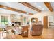 Bright living room with stone fireplace, hardwood floors and a view to the exterior at 8133 Strawberry Ln, Charlotte, NC 28277