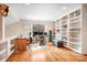 Bright home office features hardwood floors, built in bookcase, and oversized window at 8133 Strawberry Ln, Charlotte, NC 28277
