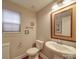 Well-lit powder room featuring a pedestal sink, decorative mirror, and modern fixtures at 105 Blossom Ridge Dr, Mooresville, NC 28117