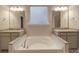 Bathroom with a soaking tub, dual sinks, granite countertops and modern fixtures at 105 Blossom Ridge Dr, Mooresville, NC 28117