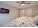 Comfortable bedroom featuring a ceiling fan, a wall-mounted TV, and a large bed with bright comforter at 105 Blossom Ridge Dr, Mooresville, NC 28117