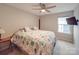 Cozy bedroom with a ceiling fan, window, and a beach themed comforter on the bed at 105 Blossom Ridge Dr, Mooresville, NC 28117