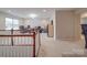Large bonus room with staircase, carpet flooring, with desk and additional home office setup at 105 Blossom Ridge Dr, Mooresville, NC 28117