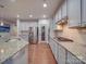 Well-appointed kitchen featuring granite countertops, stainless steel appliances, and a sleek gas cooktop at 105 Blossom Ridge Dr, Mooresville, NC 28117