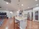 Stylish kitchen island with pendant lighting and seating, seamlessly connected to the living area at 105 Blossom Ridge Dr, Mooresville, NC 28117