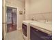 Spacious laundry room with modern appliances and shelving, conveniently located near a stairway at 105 Blossom Ridge Dr, Mooresville, NC 28117