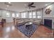 Open-concept living room with hardwood floors, fireplace, and large sectional sofa at 105 Blossom Ridge Dr, Mooresville, NC 28117