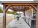 Outdoor kitchen with a built-in grill and wooden pergola, perfect for outdoor entertaining at 105 Blossom Ridge Dr, Mooresville, NC 28117
