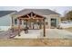 Outdoor patio featuring a grill, fire pit, and a covered pergola, perfect for backyard gatherings at 105 Blossom Ridge Dr, Mooresville, NC 28117