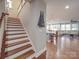 Elegant staircase leading to an open-concept living area, featuring hardwood steps and white risers at 105 Blossom Ridge Dr, Mooresville, NC 28117