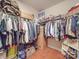 A very large walk-in closet with wooden floors, shelving and hanging areas for clothes and other accessories at 105 Blossom Ridge Dr, Mooresville, NC 28117