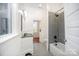 Bathroom featuring tiled floors, a modern vanity, a bathtub and shower with tiled wall and a flower vase at 116 Rose Ter, Wadesboro, NC 28170