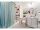 Bright bathroom featuring a bathtub with shower, modern vanity, round mirror, and soft decor at 116 Rose Ter, Wadesboro, NC 28170