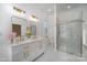 Bright bathroom showcasing a double vanity with gold hardware, marble floors, and a glass-enclosed shower at 116 Rose Ter, Wadesboro, NC 28170