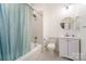 Bright bathroom featuring a bathtub with shower, modern vanity, round mirror, and soft decor at 116 Rose Ter, Wadesboro, NC 28170