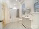 Bright bathroom features a shower-tub combo with a tiled surround, grey tile floor, and a modern vanity at 116 Rose Ter, Wadesboro, NC 28170
