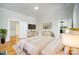 Comfortable bedroom with white bedding, wood floors, and white dresser with gold trim at 116 Rose Ter, Wadesboro, NC 28170
