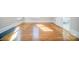 A bedroom with hardwood floors, white trim, and natural light with doorway to bathroom at 116 Rose Ter, Wadesboro, NC 28170