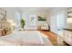 Bright bedroom featuring hardwood floors, large windows, and a chic accent chair with gold accents at 116 Rose Ter, Wadesboro, NC 28170