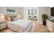Comfortable staged bedroom with large windows, light wood floors, and seating area at 116 Rose Ter, Wadesboro, NC 28170