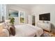 Staged bedroom with white bedding, wood floors, and white dresser with gold trim at 116 Rose Ter, Wadesboro, NC 28170