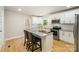 Well-equipped kitchen with granite countertops, stainless steel appliances, and island with breakfast bar at 116 Rose Ter, Wadesboro, NC 28170
