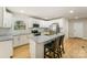 Modern kitchen featuring white cabinets, stainless steel appliances, and a granite island with breakfast bar at 116 Rose Ter, Wadesboro, NC 28170