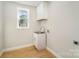 Laundry room with white cabinets, utility sink, and a window at 116 Rose Ter, Wadesboro, NC 28170