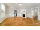 Bright living room featuring hardwood floors and a cozy fireplace with decorative white paneling at 116 Rose Ter, Wadesboro, NC 28170