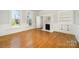Inviting living room featuring beautiful wood floors, fireplace and natural light from the large windows at 116 Rose Ter, Wadesboro, NC 28170
