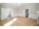 Bright living room featuring hardwood floors, white trim, and an open layout with access to the bathroom and hallway at 116 Rose Ter, Wadesboro, NC 28170